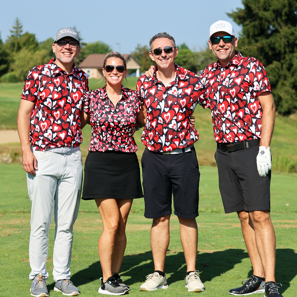Golf foursome in matching red, white, and black shirts.
